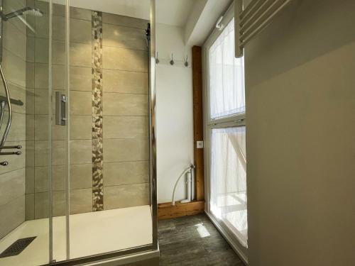 a shower with a glass door in a bathroom at Studio Les Menuires, 1 pièce, 4 personnes - FR-1-452-230 in Les Menuires