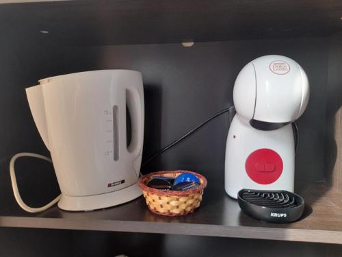 a coffee maker and a blender on a shelf at FOTIADIS BOUTIQUE RООМS and STUDIOS in Veliko Tŭrnovo