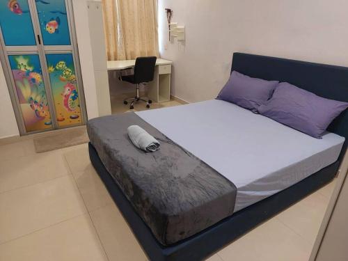 a bedroom with a large bed with purple pillows at Home in Gelugor4R3B Dnaz Homestay@Sg. Dua in Gelugor