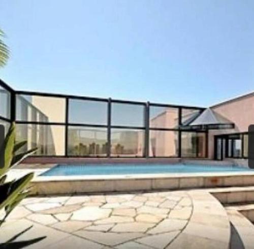 a swimming pool in the middle of a house at Apart Hotel 48 in Mogi das Cruzes