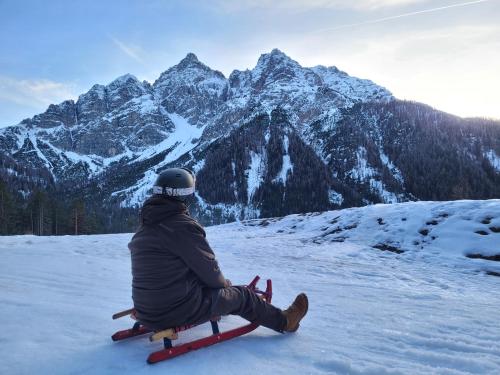 a person sitting on skis on a snow covered mountain at Ferienwohnung Annemarie in Mieders