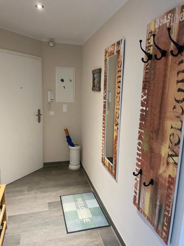 a room with a mirror on a wall at Apartment Strandglück in Dierhagen