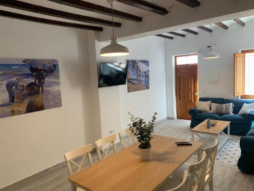 a living room with a table and a blue couch at Home SEA&DREAMS OldTown VI in Calpe