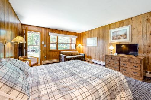 a bedroom with a bed and a television in it at King Birch Lake Home, Unit 6 in Alton