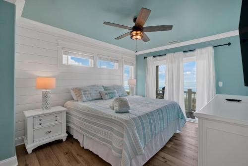 sypialnia z łóżkiem i wentylatorem sufitowym w obiekcie Key to Paradise w mieście Oak Island