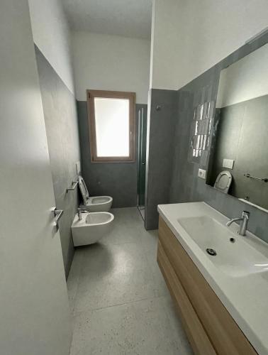 a bathroom with a toilet and a sink and a toilet istg at Appartamento AL FARO in Alba Adriatica