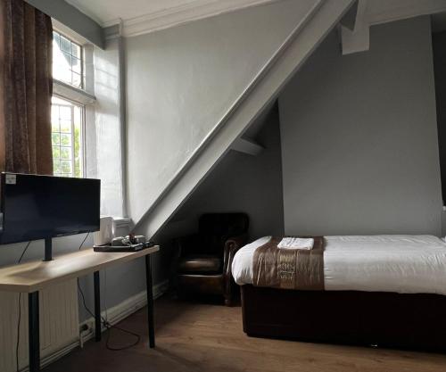 Postel nebo postele na pokoji v ubytování Assheton Hotel