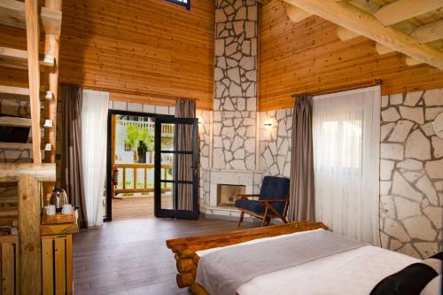 a bedroom with a bed and a fireplace at MUKHA ORMANLI in Ormanlı