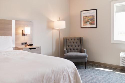 a hotel room with a bed and a chair at Brady Hotel in New Florence
