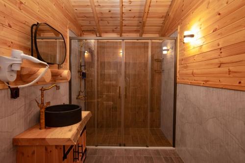 a shower with a glass door in a bathroom at MUKHA ORMANLI in Ormanlı