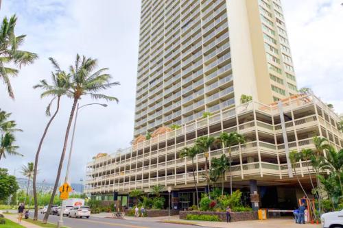 a tall building with palm trees in front of it at Island Colony 3519 - 30 night minimum in Honolulu