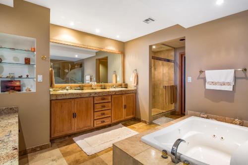 a bathroom with a tub and two sinks and a shower at Club Marena Condo 501 in Rosarito
