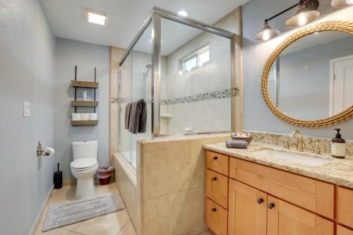 a bathroom with a tub and a sink and a mirror at Family Home with Pool about 7 Mi to Downtown Sacramento! in Sacramento