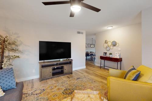 a living room with a flat screen tv on a wall at Palm Reflection in Mesa