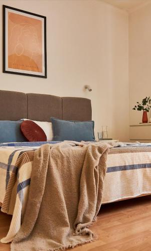 a bedroom with a bed with a blanket on it at Wonderful Panoramic View Apartment in Mukacheve
