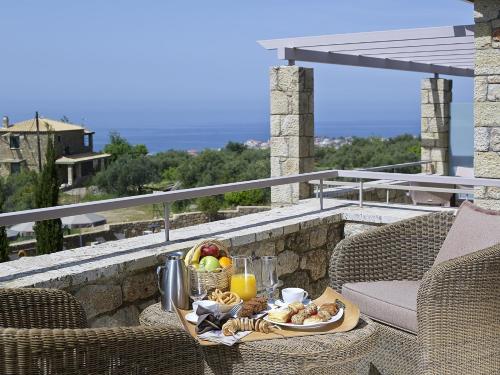 a tray of food on a table on a balcony at Anaxo Resort in Riglia