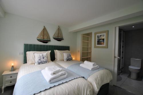 a bedroom with a large bed with towels on it at The Old Stables- charming cottage Crail in Crail