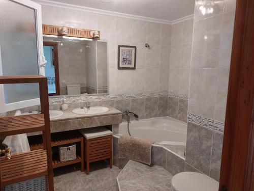 y baño con lavabo, bañera y aseo. en Chalet urbano en Salamanca en Santa Marta de Tormes