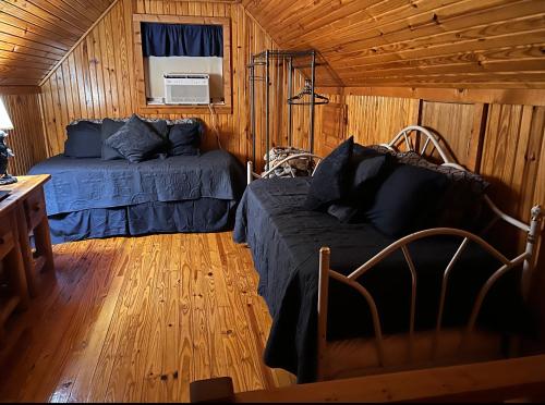 1 dormitorio con 1 cama y 1 sofá en una cabaña en Lake Whitney Log Cabin, en Lakewood Harbor