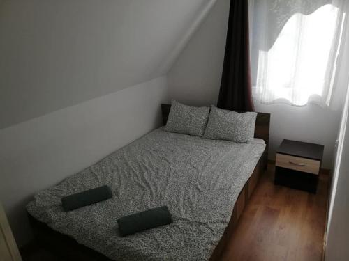 a small bedroom with a bed and a window at Casa Fresh in Sântimbru-Băi