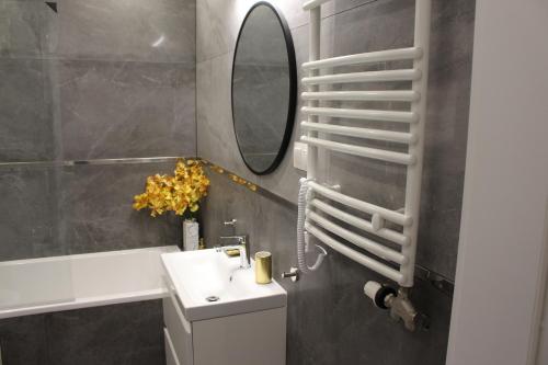 a bathroom with a sink and a mirror at Apartament Euro 2 Kraków in Krakow