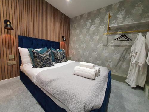 a bedroom with a bed with towels on it at Stylish Ashford Gem - Sleeps 6 in Kent