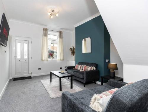 a living room with a couch and a table at The Normanby! in Normanby