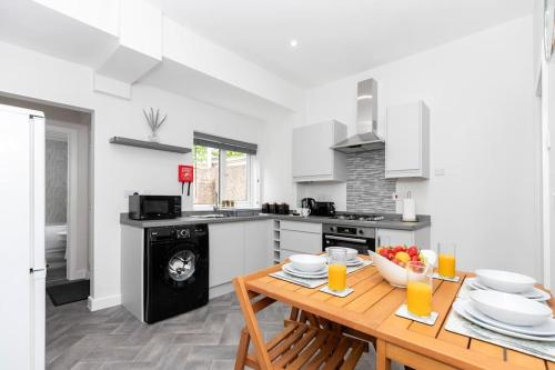 a kitchen with a wooden table and a dining room at The Normanby! in Normanby