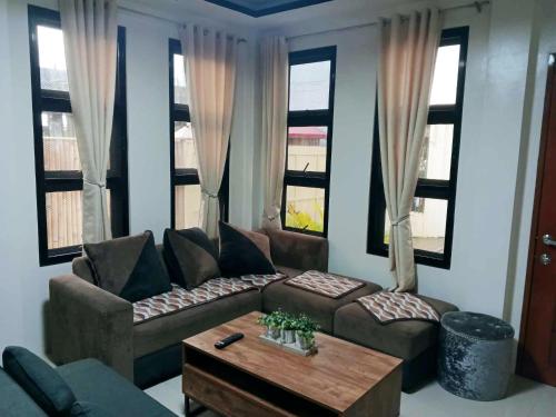 a living room with a couch and a coffee table at Baladad Transient House in San Fernando