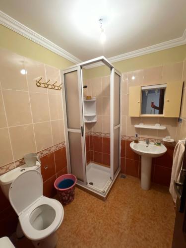 a bathroom with a shower and a toilet and a sink at Arena beach in Martil