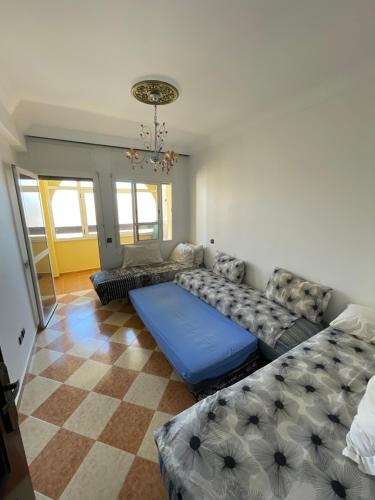 a living room with a couch and a checkerboard floor at Arena beach in Martil