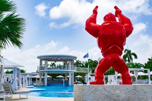 a statue of a red crab in front of a pool at Playa Palmera Beach Resort in Punta Cana