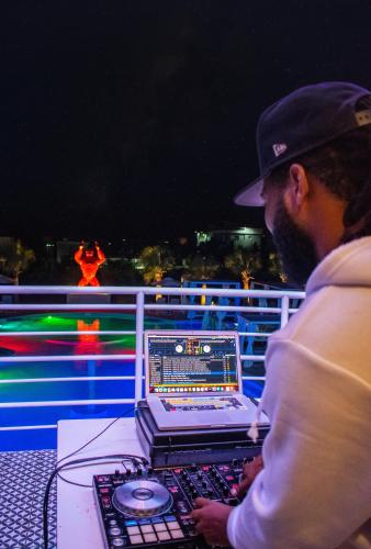 a man working on a laptop computer on a deck at Playa Palmera Beach Resort in Punta Cana