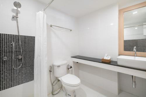a bathroom with a toilet and a sink and a shower at G Boutique Silom Hotel in Bangkok