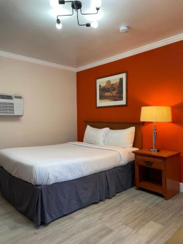 a hotel room with two beds and a lamp at Howard Johnson by Wyndham Ridgecrest, CA in Ridgecrest