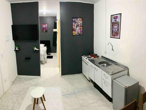 a small bathroom with a sink and a toilet at Loft Mobiliado com Cama de Casal e Solteiro in Passo Fundo