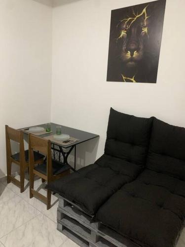 a living room with a couch and a table at Loft Mobiliado com Cama de Casal e Solteiro in Passo Fundo