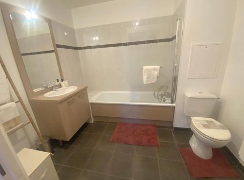 a bathroom with a toilet and a sink and a shower at "Olympic Sweet Home" Paris Stade de France in Épinay-sur-Seine