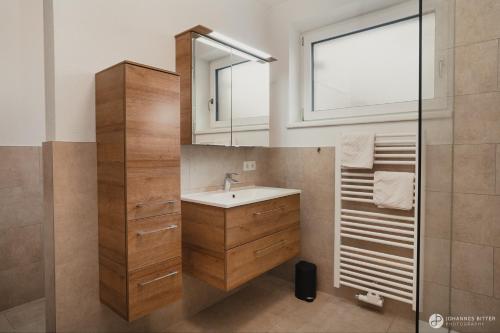 a bathroom with a sink and a mirror at Stoacherhof Apartments in Matrei am Brenner