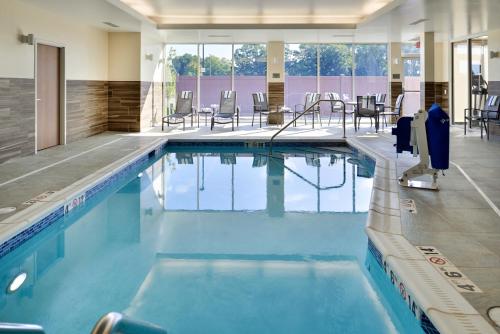 a large swimming pool with chairs and tables at Fairfield Inn and Suites by Marriott Minneapolis Shakopee in Shakopee