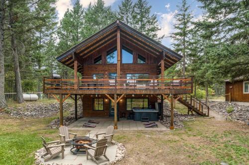 a large log cabin with a deck and a patio at Log Cabin Lookout in Bigfork