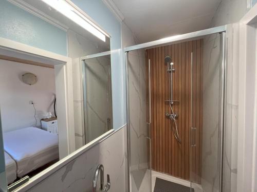 a bathroom with a shower and a glass door at Country House & Restaurant Hronec in Hronec