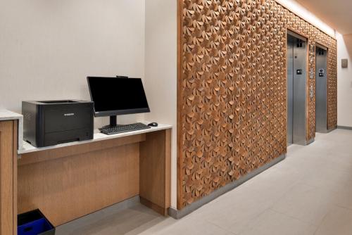 an office with a partition with a computer on a desk at Fairfield Inn and Suites by Marriott Minneapolis Shakopee in Shakopee
