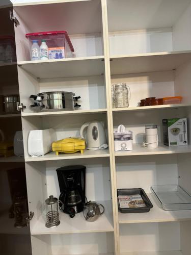 a kitchen shelf with various items on it at MiraSierraHome... Tú hogar de vacaciones! in Alora
