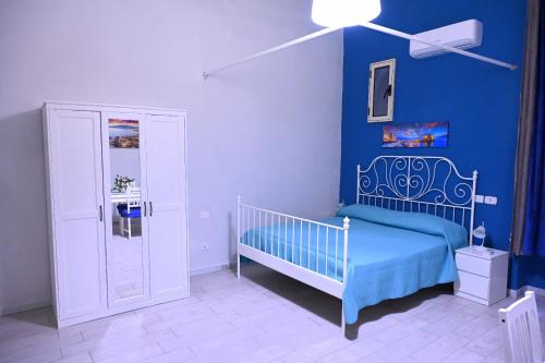 um quarto azul com um berço e uma parede azul em Casa Don Renato em Nápoles