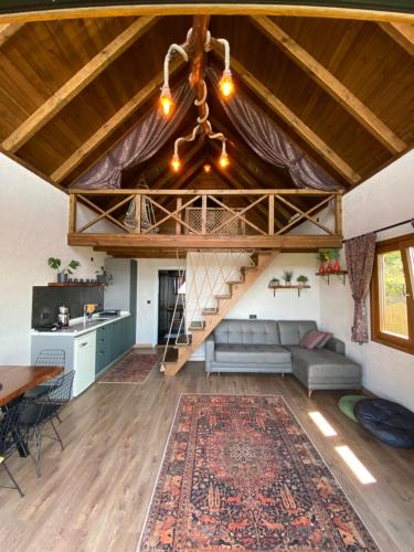 a living room with a couch and a staircase at Lavinya Suit Bungalov in Rize