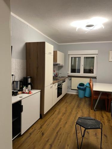 a kitchen with white appliances and a wooden floor at Apartment 7+1 in Murg