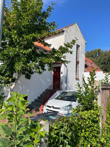 a white car parked in front of a house at Sølyst in Silkeborg