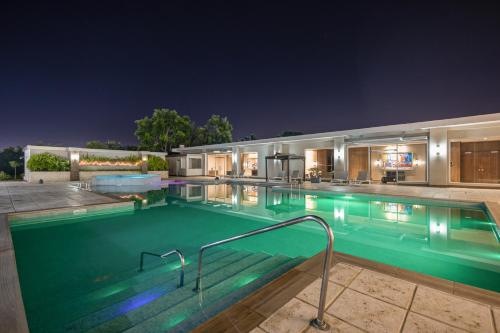 a swimming pool at night in a house at Crowne Plaza Airport by IHG in Tocumen