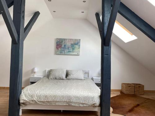 a bedroom with a bed in a attic at Le 189 : Superbe triplex centre Béthune in Béthune